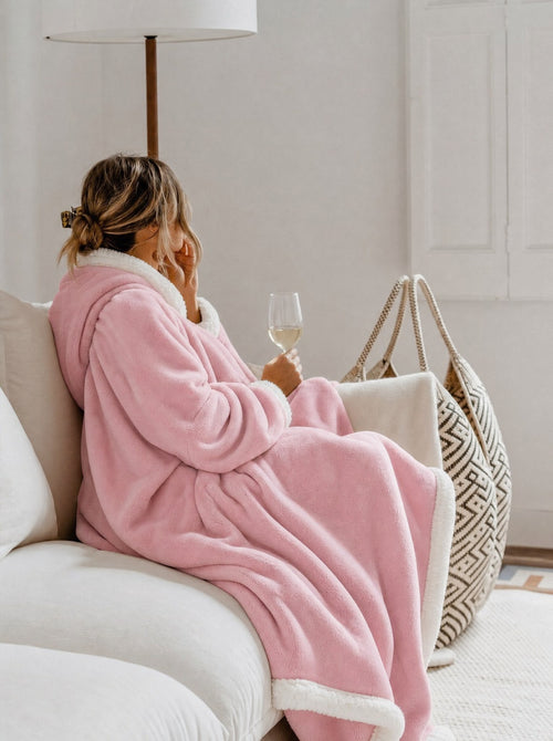 Cozella Longline Blanket Robe in Blush Pink worn on a cream sofa