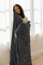 Cozella Ribbed Plush Throw in Charcoal wrapped around a woman, full drape