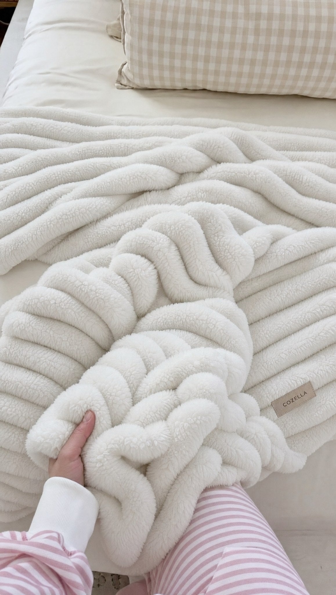 Hands pressed into the deep ribbed pile of the Cozella throw in White